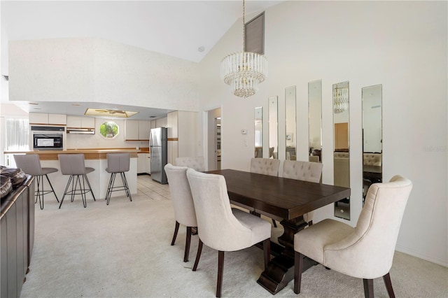 carpeted dining area with a notable chandelier and high vaulted ceiling