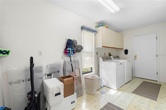 laundry room with independent washer and dryer and cabinets