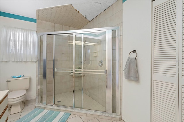 bathroom featuring vanity, tile patterned flooring, toilet, and an enclosed shower