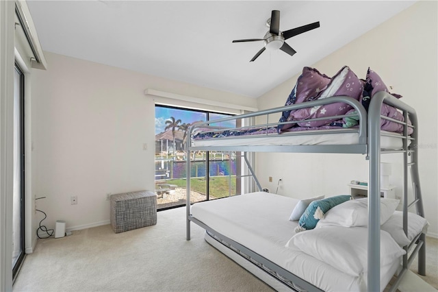 carpeted bedroom with access to outside, multiple windows, lofted ceiling, and ceiling fan