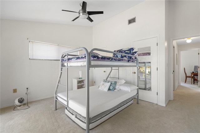 carpeted bedroom featuring vaulted ceiling and ceiling fan