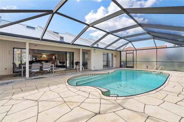 view of swimming pool featuring a patio and glass enclosure