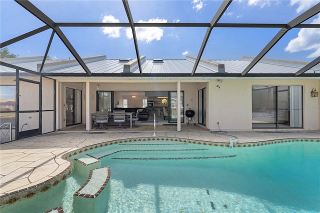 view of swimming pool featuring a patio and glass enclosure