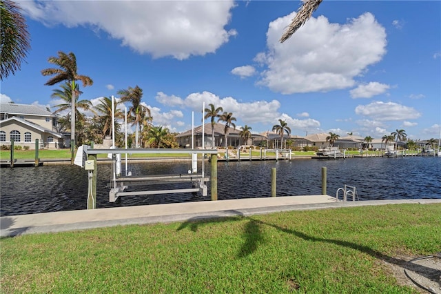 dock area with a water view and a yard