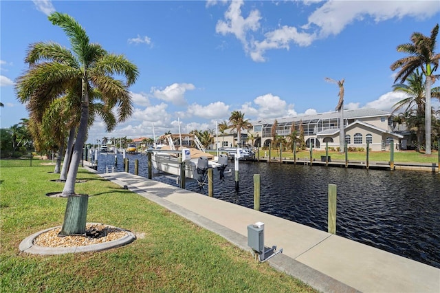 dock area featuring a water view and a lawn