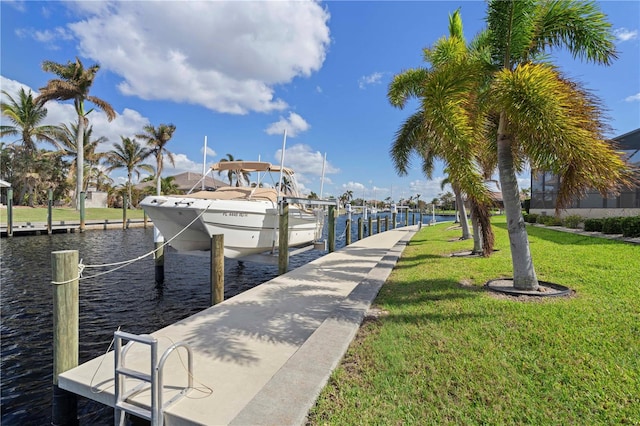 dock area with a yard and a water view