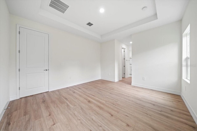 3390 Nadasky Ave, North Port, FL 34288 - spare room with a tray ceiling, light wood-type flooring, baseboards, and recessed lighting