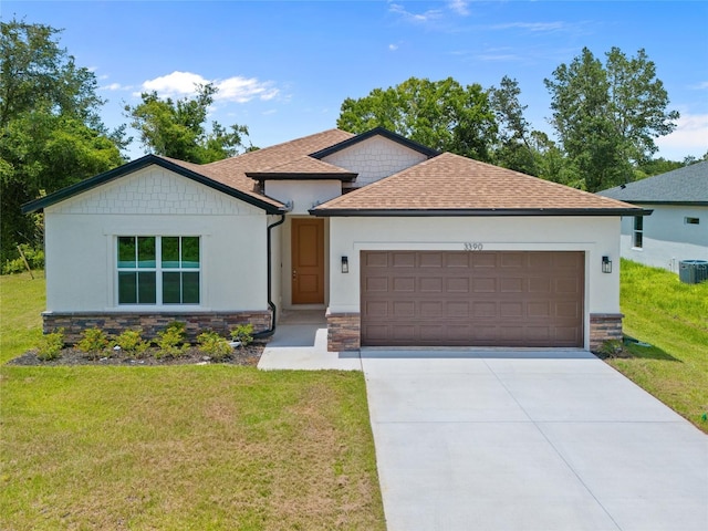 3390 Nadasky Ave, North Port, FL 34288 - view of front of property with stone siding, concrete driveway, roof with shingles, a front yard, and a garage