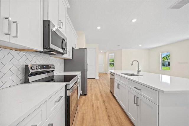 3390 Nadasky Ave, North Port, FL 34288 - kitchen with appliances with stainless steel finishes, a sink, decorative backsplash, plenty of natural light, and recessed lighting