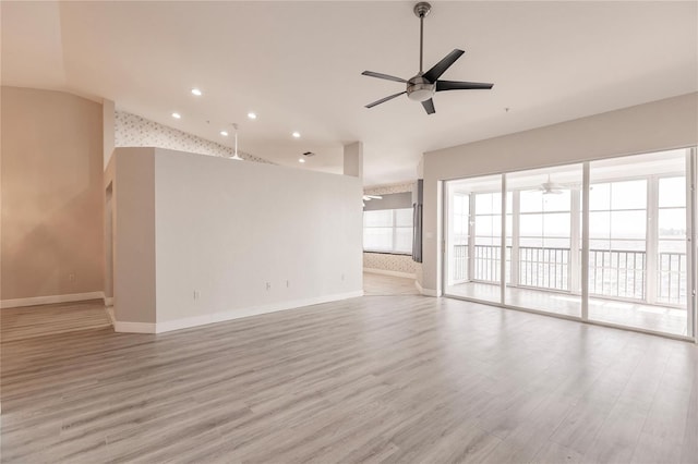 unfurnished living room featuring ceiling fan and light hardwood / wood-style flooring