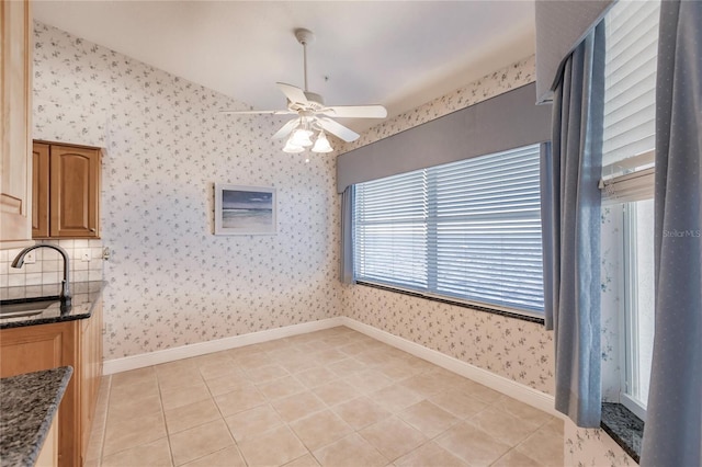 tiled dining area with sink and ceiling fan