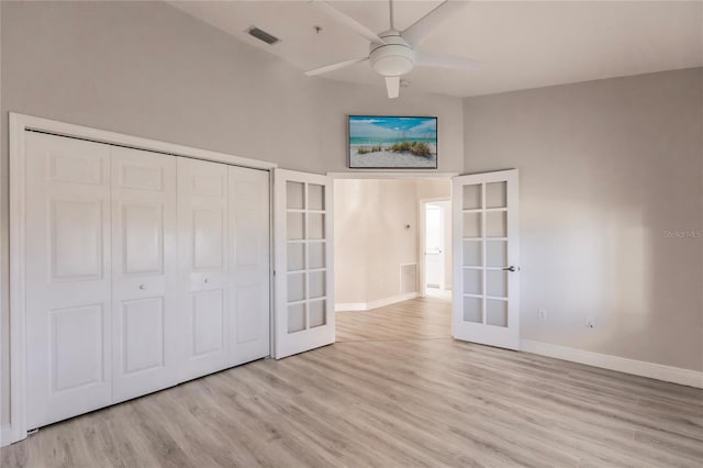 unfurnished bedroom featuring a closet, french doors, ceiling fan, and light hardwood / wood-style flooring