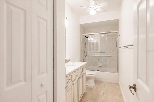 full bathroom with ceiling fan, shower / bath combination with glass door, vanity, tile patterned floors, and toilet