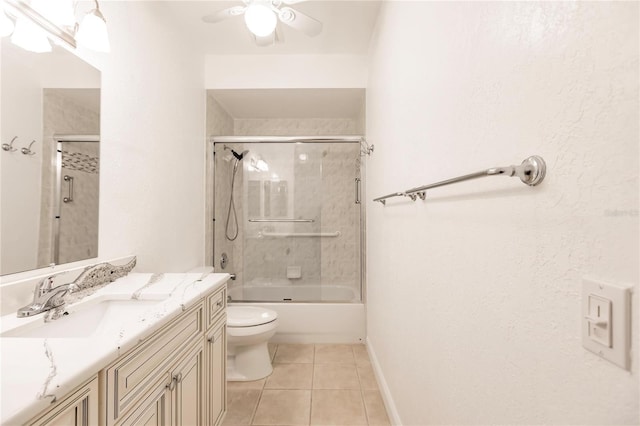 full bathroom featuring enclosed tub / shower combo, vanity, tile patterned flooring, toilet, and ceiling fan