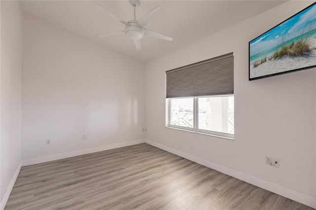 empty room featuring ceiling fan and light hardwood / wood-style flooring