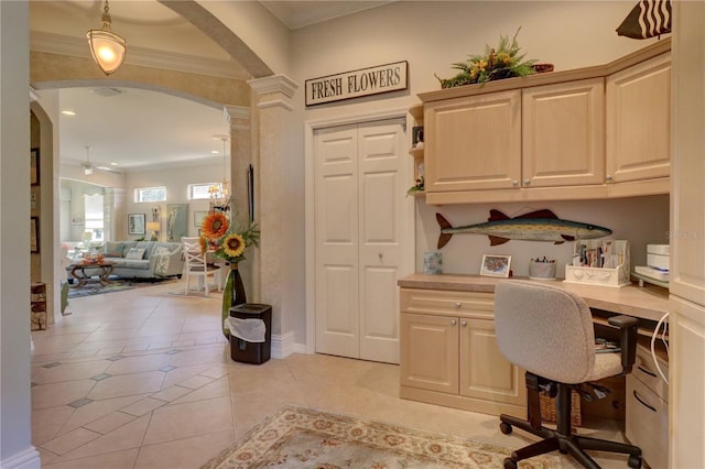 tiled office featuring built in desk, ornate columns, crown molding, and ceiling fan