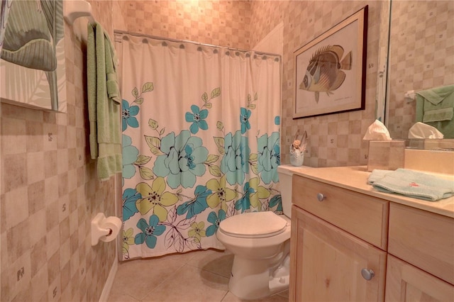 bathroom with vanity, toilet, tile patterned floors, and walk in shower