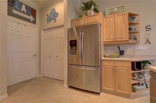 kitchen with crown molding, stainless steel fridge with ice dispenser, light tile patterned flooring, and light brown cabinets