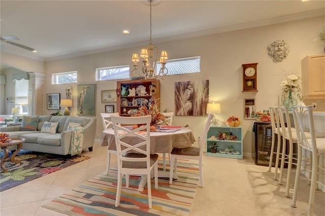 tiled dining area with ornamental molding and an inviting chandelier