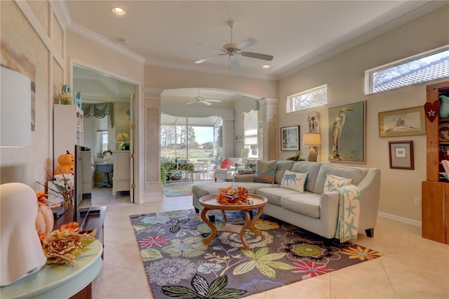 tiled living room featuring crown molding, decorative columns, and ceiling fan