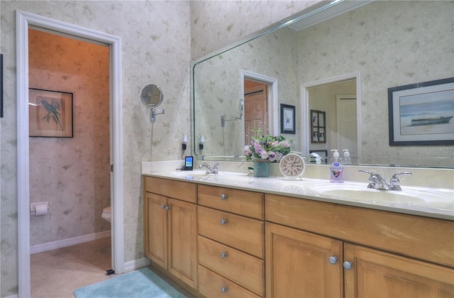 bathroom with vanity, toilet, and tile patterned floors