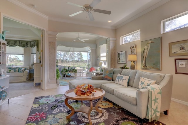 tiled living room featuring ornamental molding, ceiling fan, and decorative columns