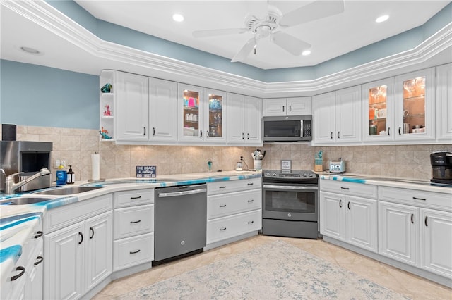 kitchen featuring white cabinets, tasteful backsplash, a raised ceiling, sink, and stainless steel appliances