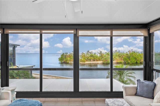 sunroom with a healthy amount of sunlight and a water view