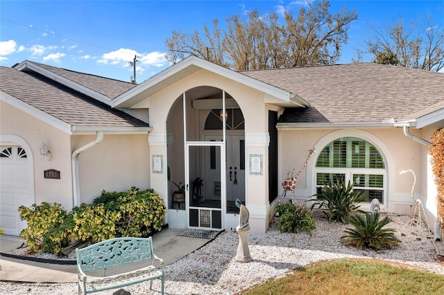 view of exterior entry with a garage