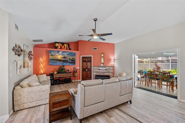 living room with vaulted ceiling, ceiling fan, and light hardwood / wood-style flooring