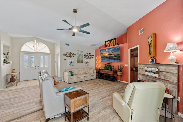 living room with light wood-type flooring, vaulted ceiling, and ceiling fan