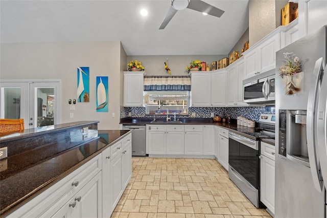 kitchen with stainless steel appliances, white cabinetry, and sink