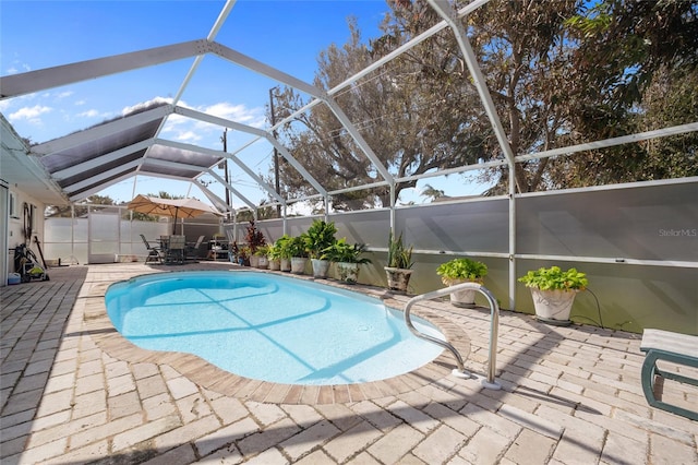 view of pool with a lanai and a patio area