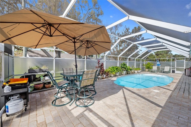 view of pool featuring glass enclosure and a patio area