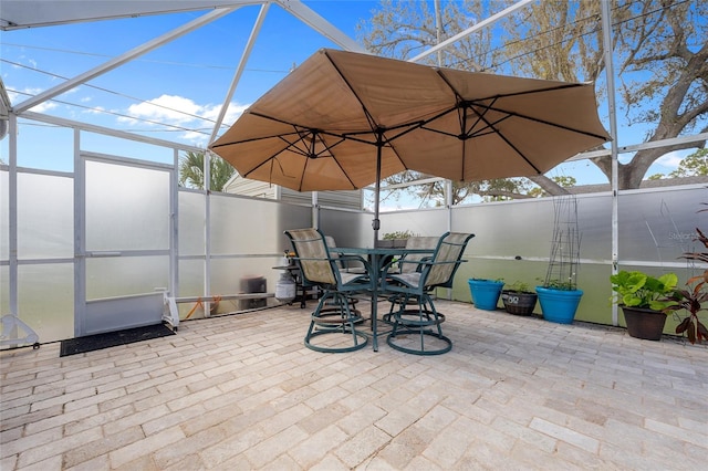 view of patio / terrace featuring a lanai