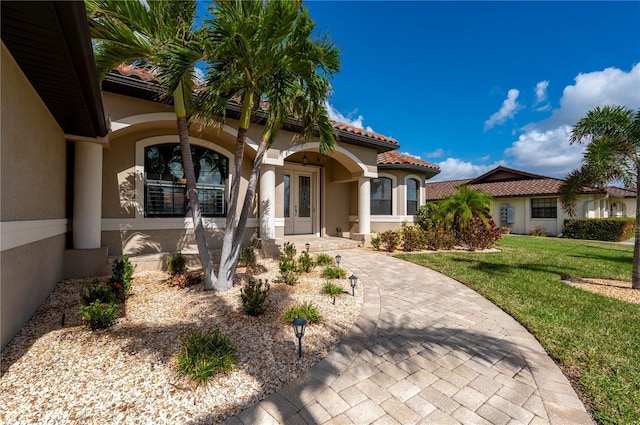 2736 Magdalina Dr, Punta Gorda, FL 33950 - mediterranean / spanish house with french doors, a front yard, and stucco siding