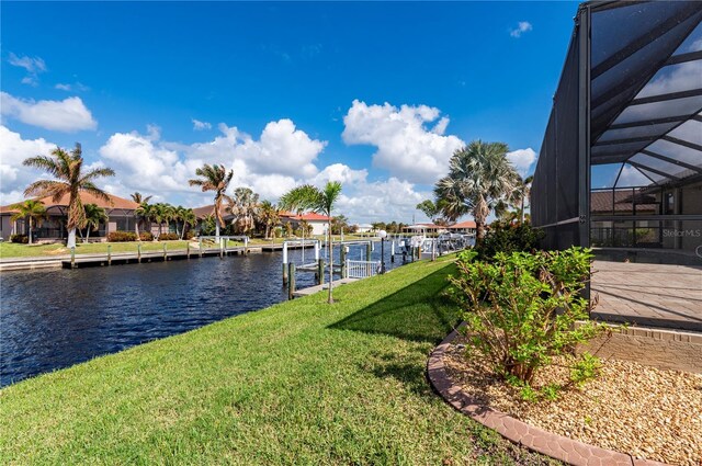 2736 Magdalina Dr, Punta Gorda, FL 33950 - dock area with a lanai, a residential view, boat lift, a yard, and a water view