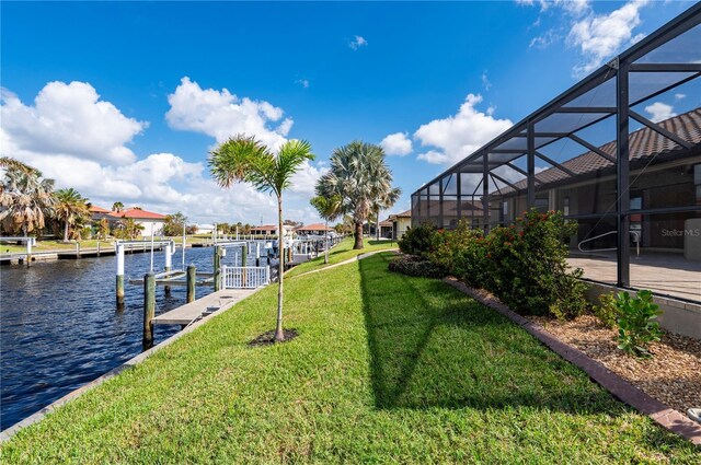 2736 Magdalina Dr, Punta Gorda, FL 33950 - view of dock with a water view, glass enclosure, boat lift, and a yard