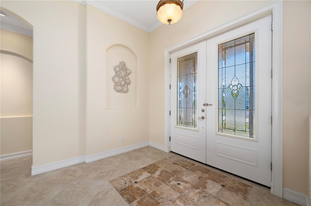 2736 Magdalina Dr, Punta Gorda, FL 33950 - entrance foyer featuring ornamental molding, baseboards, tile patterned floors, french doors, and arched walkways