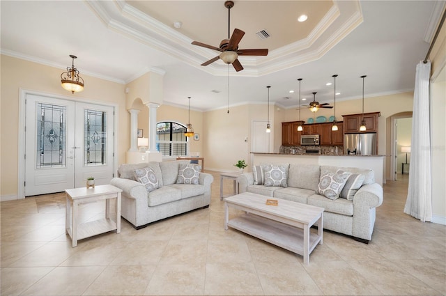 2736 Magdalina Dr, Punta Gorda, FL 33950 - living area with visible vents, crown molding, arched walkways, a tray ceiling, and a ceiling fan