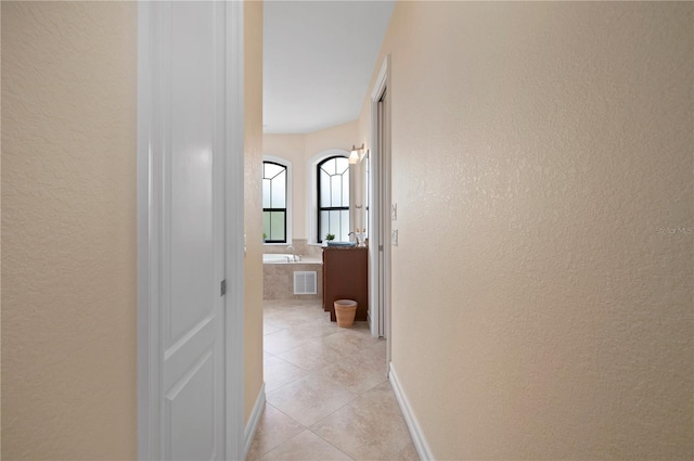 2736 Magdalina Dr, Punta Gorda, FL 33950 - hallway featuring a textured wall, visible vents, and light tile patterned floors