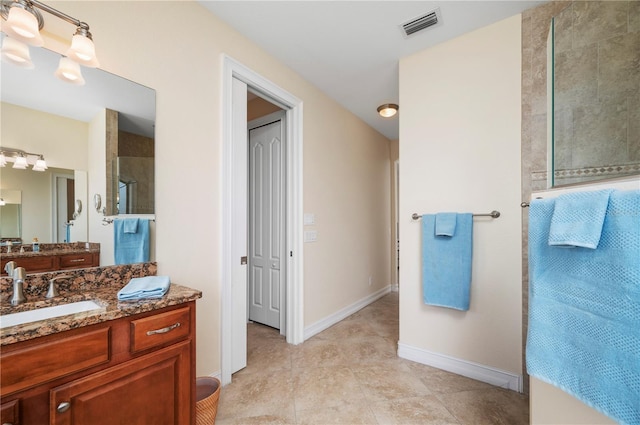 2736 Magdalina Dr, Punta Gorda, FL 33950 - bathroom featuring visible vents, vanity, baseboards, tile patterned floors, and a tile shower