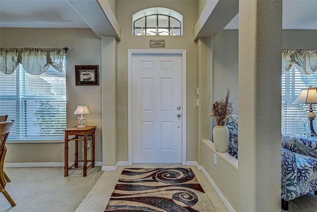 foyer entrance with light carpet