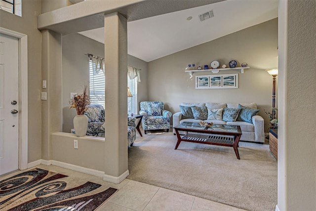 foyer entrance with lofted ceiling and light colored carpet