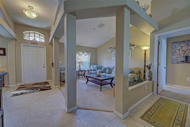 entryway featuring high vaulted ceiling and light tile patterned floors