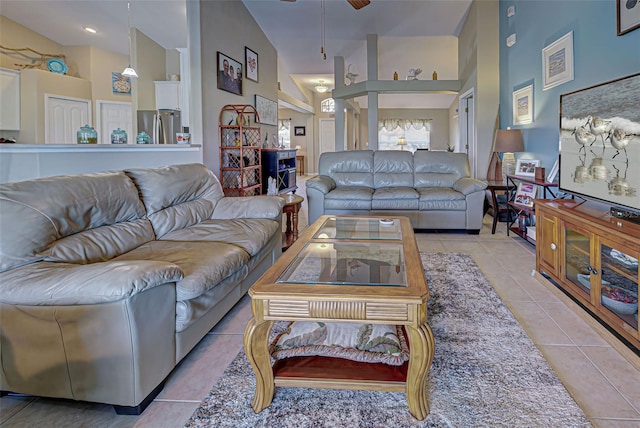 living room featuring light tile patterned flooring, high vaulted ceiling, and ceiling fan