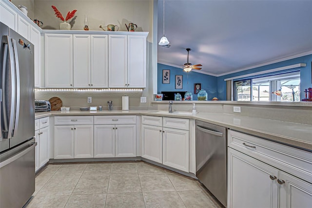 kitchen featuring ornamental molding, appliances with stainless steel finishes, white cabinetry, and light tile patterned floors