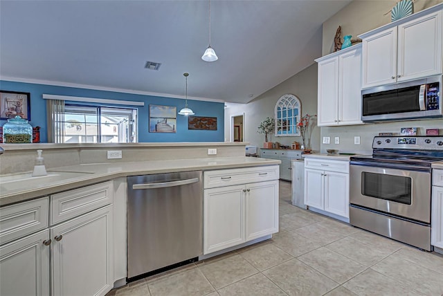 kitchen with crown molding, white cabinetry, decorative light fixtures, and stainless steel appliances