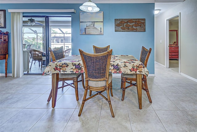 tiled dining space featuring ceiling fan