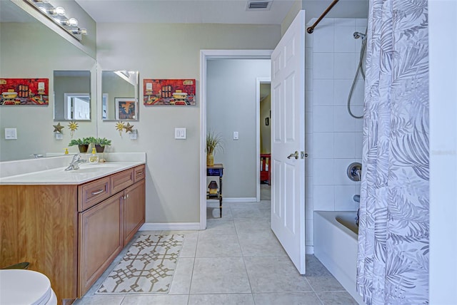 full bathroom featuring vanity, shower / bath combo with shower curtain, toilet, and tile patterned flooring